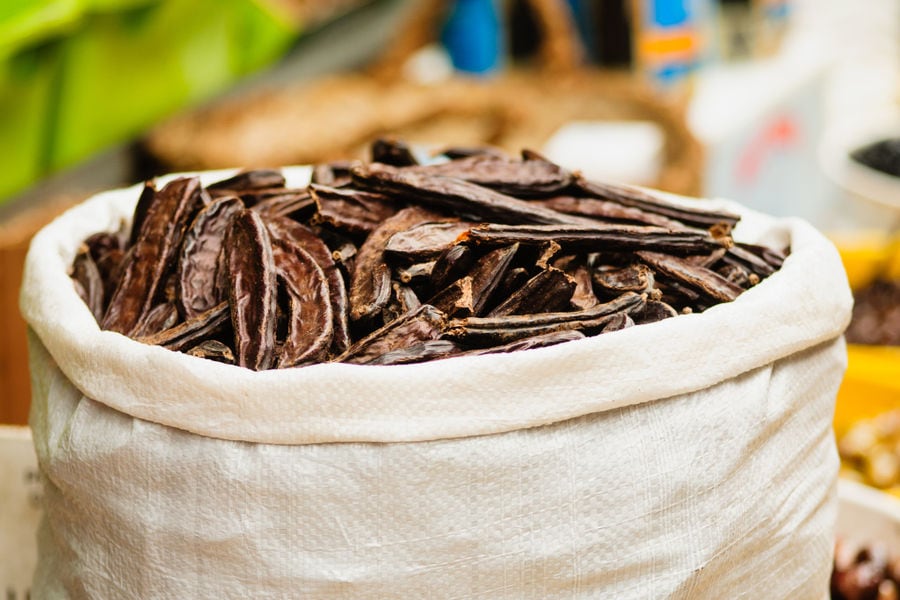 raffia sack with carob dry pods at Creta Carob